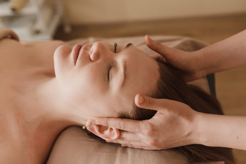 a-woman-having-a-head-massage-6663367 A calming spa facial massage focusing on relaxation and well-being.